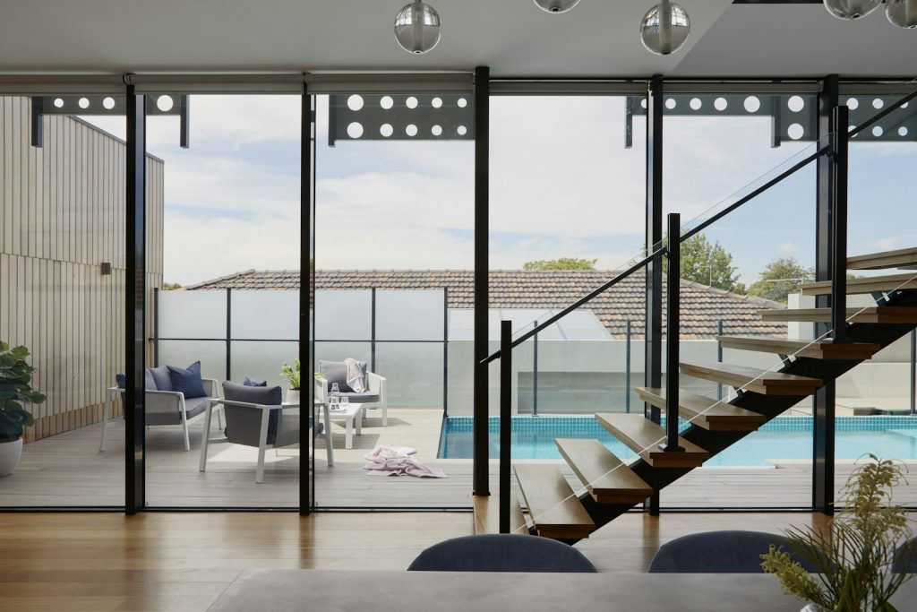 Glass-walled living room opening onto the pool at Bayfront Glass Villa