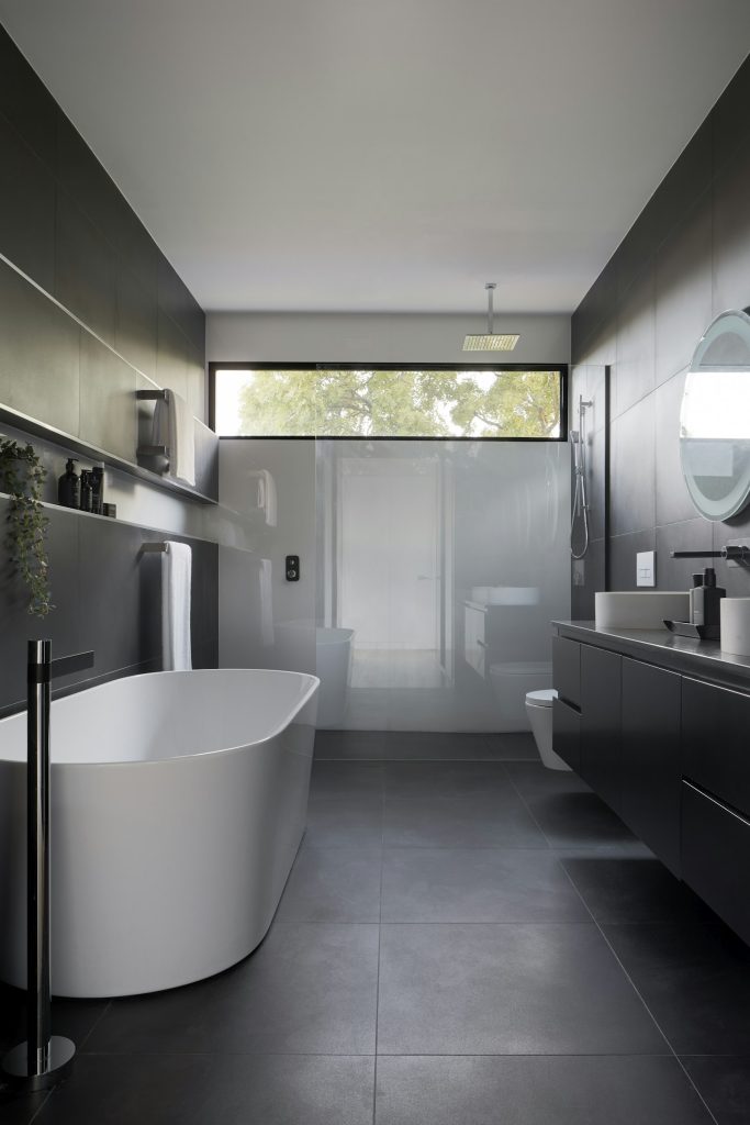 Spa-style primary bathroom with freestanding tub